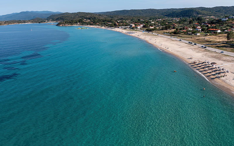 Stavros Beach is a beautiful sandy beach located in Stavros, Chalkidiki. The beach is known for its crystal-clear water, picturesque views, and serene atmosphere.